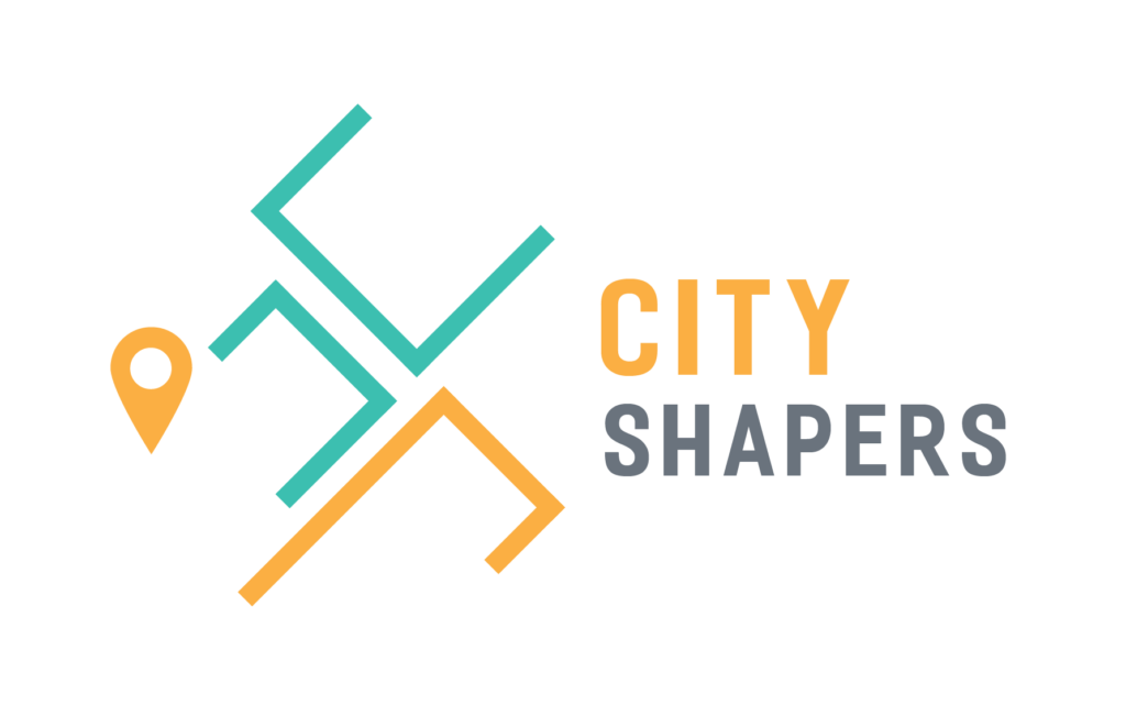 City Shapers logo which is made up of two teal blocks and one orange block as well as an orange map pin evoving high rise buildings and maps. To the right City Shapers is written in two lines, City in orange and Shapers in grey. 
